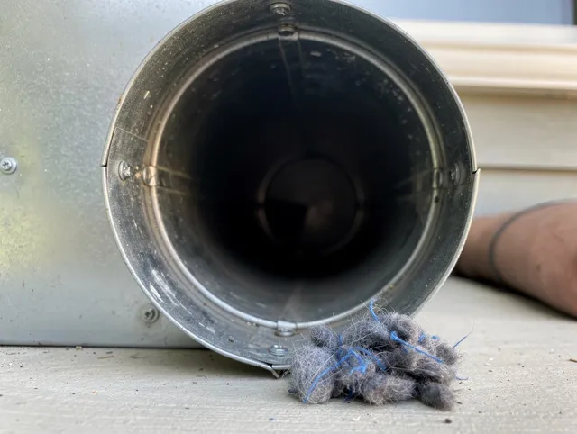 Bloomington Dryer Vent Cleaning technician using specialized equipment to clear severe dryer vent blockage in Bloomington